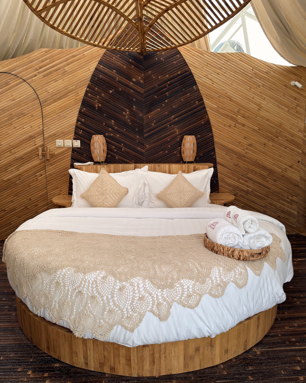 The full-circle bed angled towards the floor-to-ceiling glass
