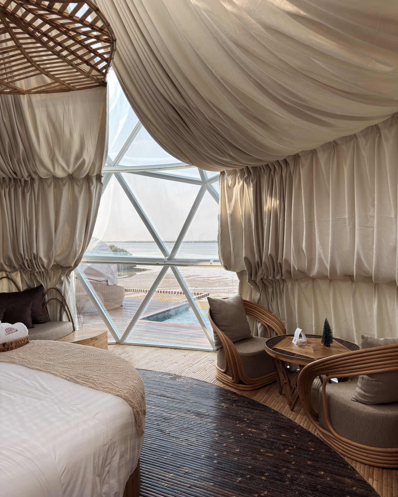 The Balinese-boho interior of a glass-domed suite